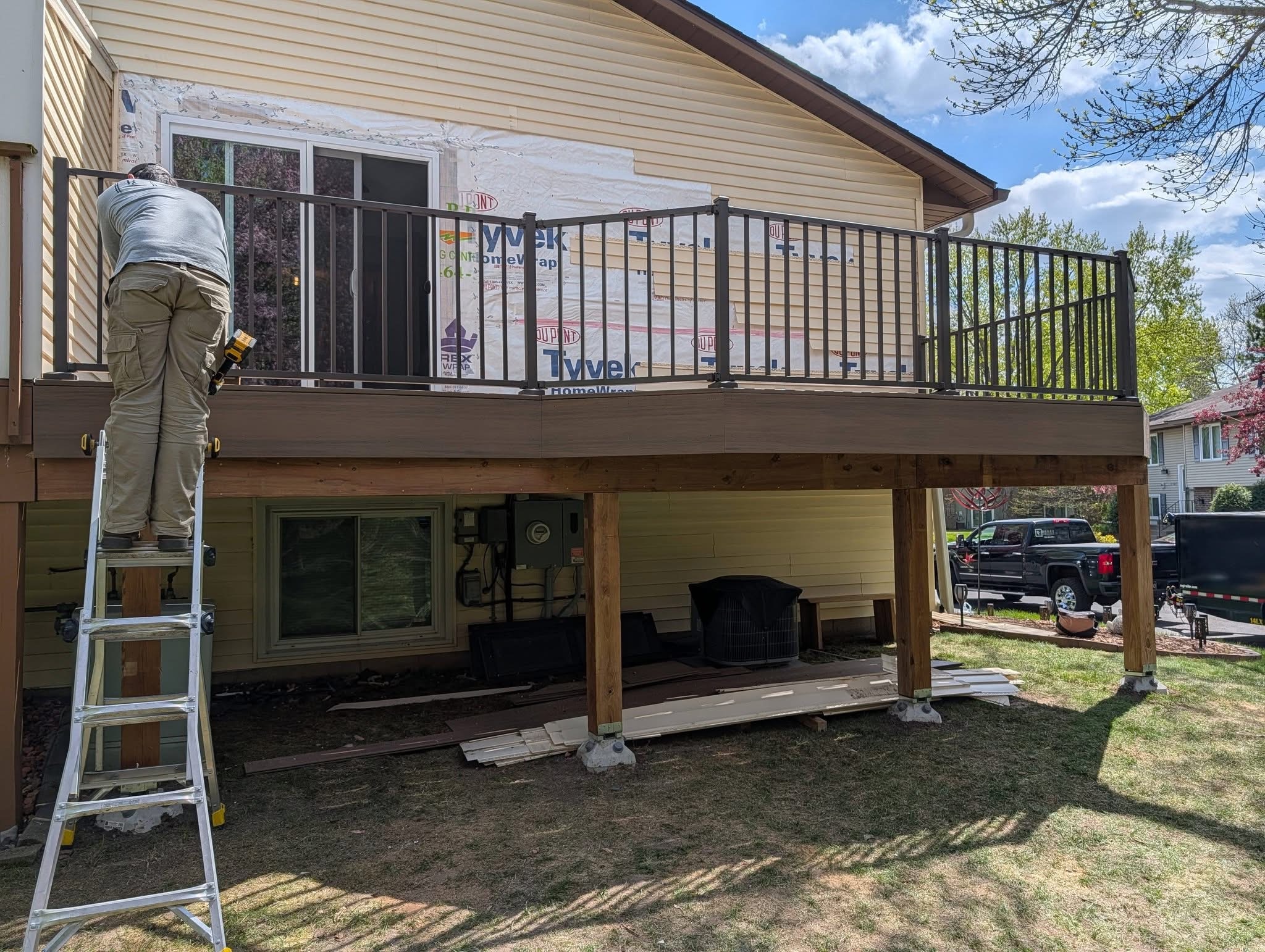 Deck'd Out LLC contractor installing deck railing